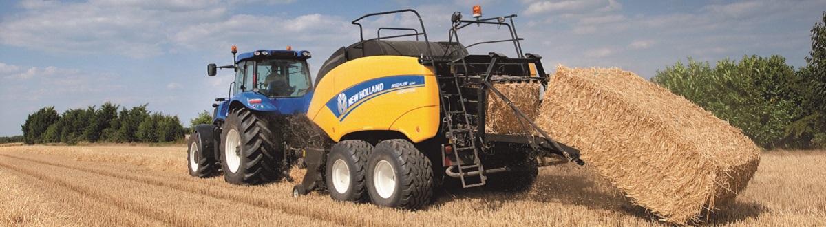 New Holland Tractor packing and droping hay